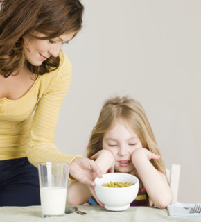 Mother serving vegetables to daughter. Date : 2008