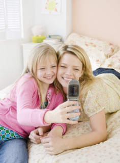 Mother and daughter taking own photograph. Date : 2008