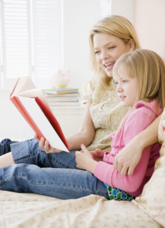 Mother reading to daughter. Date : 2008