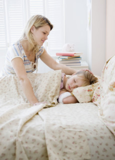 Mother watching daughter sleep. Date : 2008