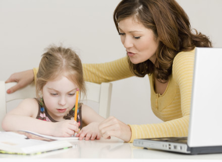 Mother helping daughter with homework. Date : 2008