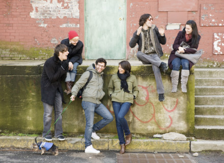 Group of friends sitting in urban scene. Date : 2008