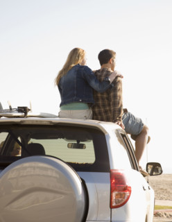Couple sitting on top of car. Date : 2008