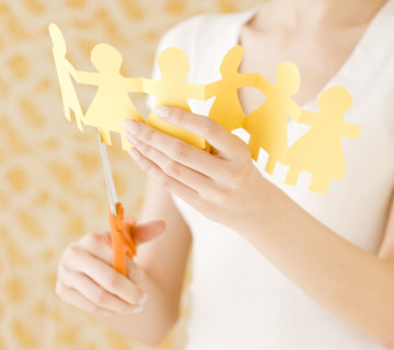 Woman cutting out paper dolls. Date : 2008