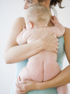 Mother hugging naked baby. Date : 2008