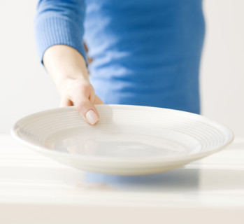 Woman holding empty dish. Date : 2008