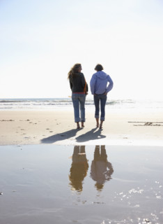 Two women walking on beach. Date : 2008