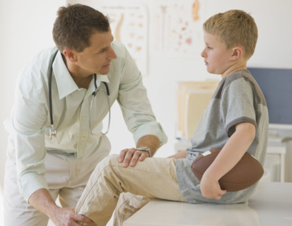 Male doctor examining boy.