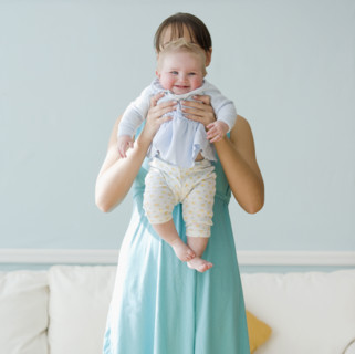 Mother holding up baby. Date : 2008