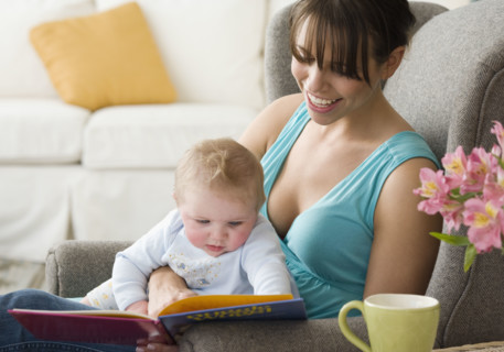 Mother and baby looking at book. Date : 2008