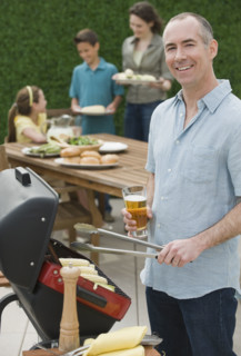Family with two children barbecuing.