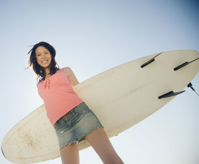 Woman holding surfboard. Date : 2008