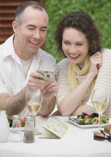 Couple looking at digital camera.