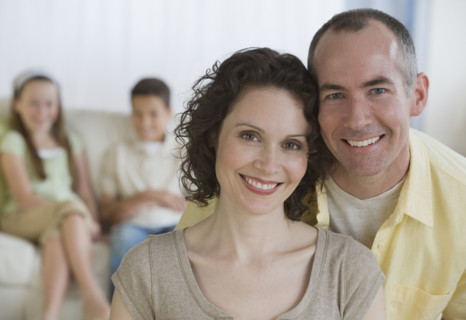 Parents with children in background.