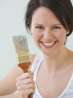 Woman holding paintbrush.