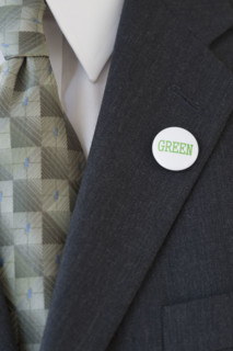 Eco-friendly button on businessman’s lapel.