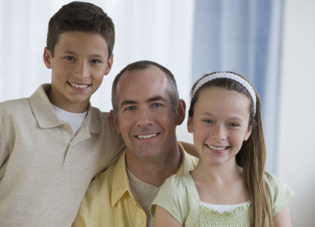 Father and children hugging.