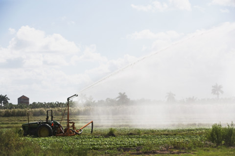 Tractor watering field, Florida, United States. Date : 2008