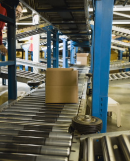 Boxes on conveyor belt in warehouse. Date : 2008