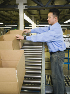Asian male factory worker checking product. Date : 2008