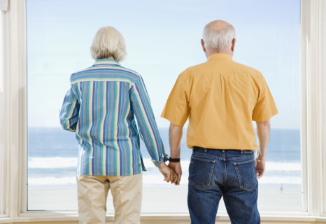 Senior couple looking out window. Date : 2008