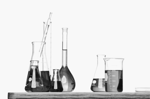 Science beakers with liquid on table. Date : 2008