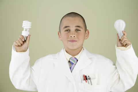 Boy holding light bulbs. Date : 2008