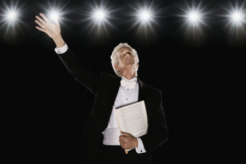 Man in tuxedo holding sheet music. Date : 2008