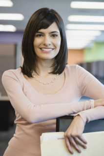 Businesswoman leaning on cubicle wall. Date : 2008
