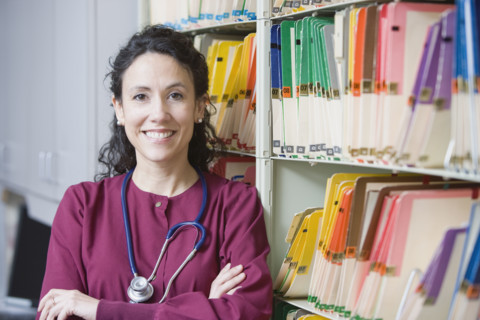 Female doctor next to charts. Date : 2008