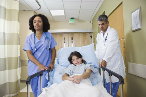 Girl being wheeling in hospital gurney. Date : 2008