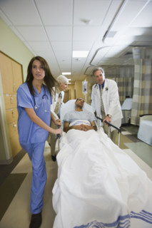 African man being wheeled in hospital gurney. Date : 2008