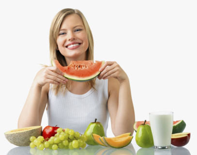 Woman with assorted fruit and glass of milk. Date : 2008