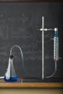 Science experiment in front of blackboard. Date : 2008