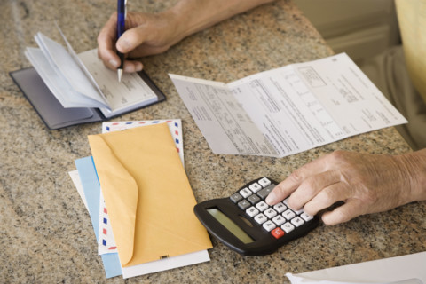 Senior man paying bills. Date : 2008