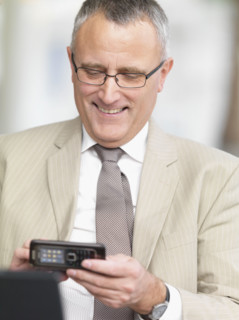 Businessman dialing cell phone. Date : 2008