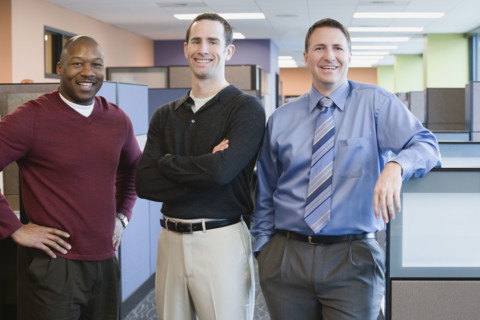 Multi-ethnic businessmen standing in office. Date : 2008