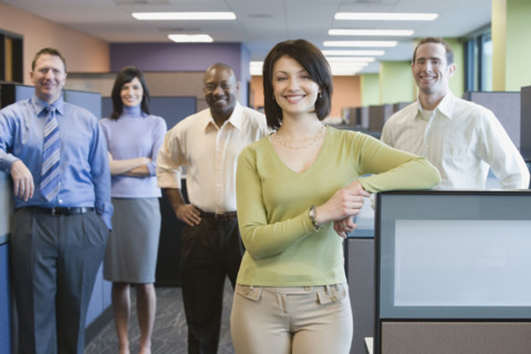 Businesswoman with multi-ethnic coworkers in background. Date : 2008