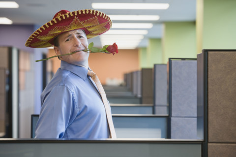 Businessman wearing sombrero and holding rose in teeth. Date : 2008