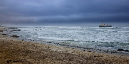 View of ocean and ship in distance, Namibia, Africa. Date : 2008