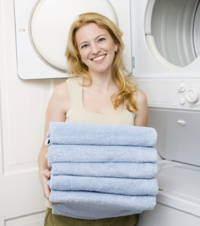Woman holding folded towels. Date : 2008