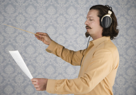 Man listening to headphones and conducting. Date : 2008