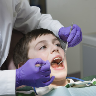 Boy being examined by dentist. Date : 2008