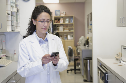 Female doctor dialing cell phone. Date : 2008