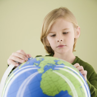 Boy looking at globe. Date : 2008