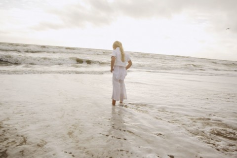 Girl standing in ocean surf. Date : 2008