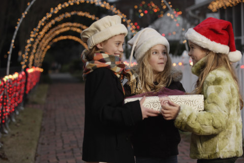 Girls holding Christmas gift. Date : 2008