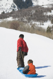 Boy pulling brother in sled. Date : 2008