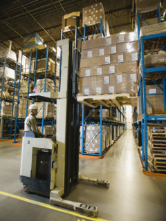 Warehouse worker driving forklift. Date : 2008