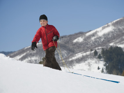 Boy pulling sled in snow. Date : 2008